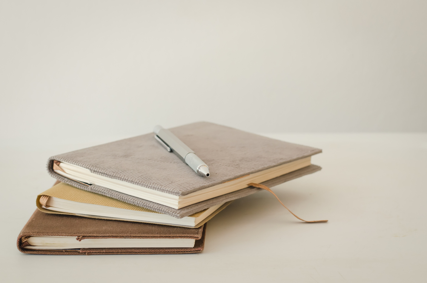 Notebooks and pen on table.